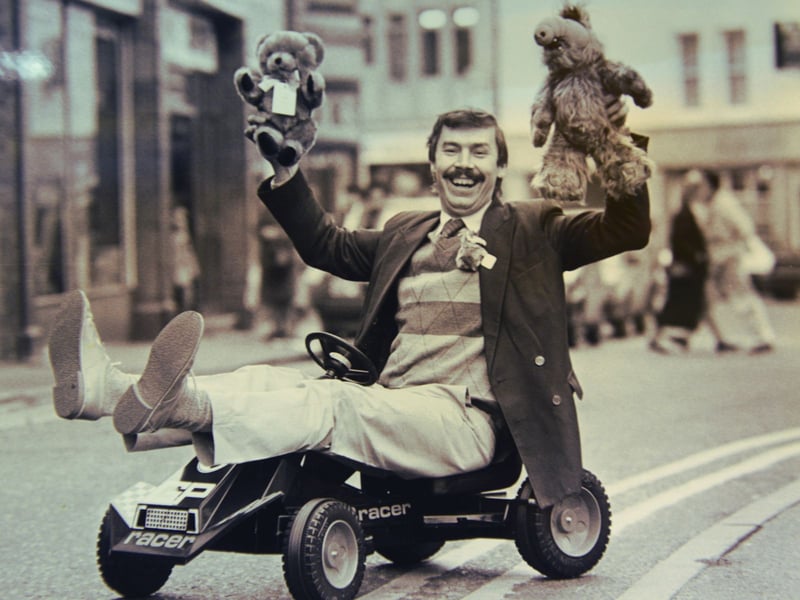 Owner Alan Caswell celebrates after The Arcade Toy Shop in Dudley was named Toy Shop of the Year in 1989. Pictured sitting in a go-kart, he holds a teddy bear in each hand as he marks the shop's success. Do you remember visiting The Arcade Toy Shop, or what you bought there?