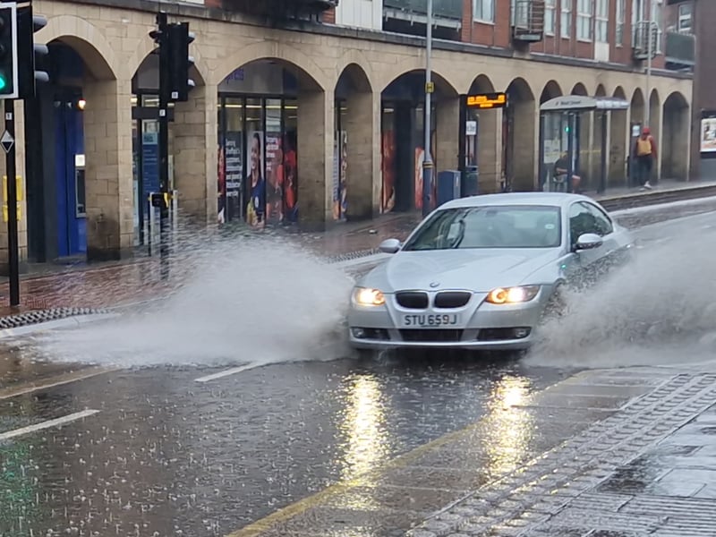 A car ploughs through a deep puddle on West Street, Sheffield. Photo: Iconic Media