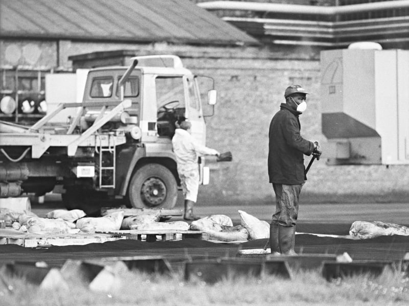Goodyear workers tackle the aftermath of a burst silo pipe at the Bushbury plant in May 1989, after carbon dust spilled out and covered hundreds of homes in the Low Hill area. One worker wears face protection as the clean-up gets under way. Do you remember the day the black dust came down over Low Hill?