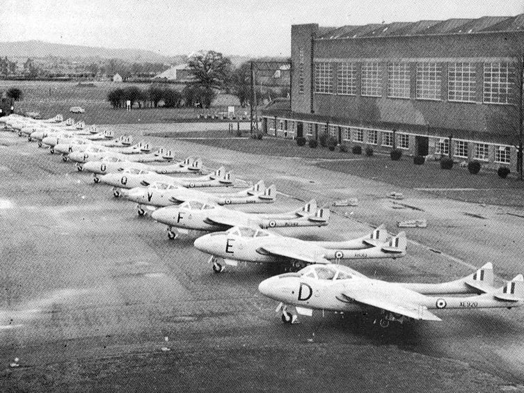Lined up in neat formation outside the hangars, a fleet of de Havilland Vampire aircraft sits on the tarmac at RAF Shawbury during the 1960s. These distinctive twin-boom jet trainers were a familiar sight in the skies over North Shropshire, capturing a golden era of military aviation and training at the base. Do you remember seeing or hearing the Vampires flying out of RAF Shawbury during the 1960s?