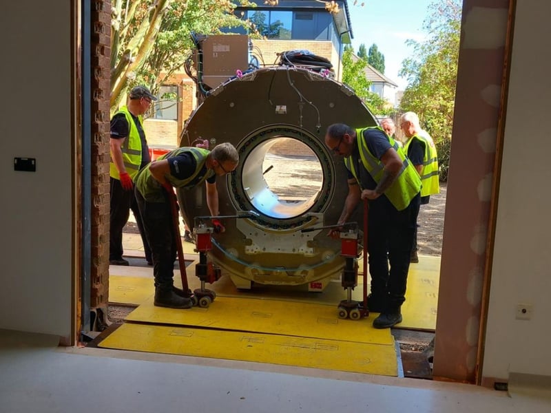 The MRI machine is carefully brought into the building.