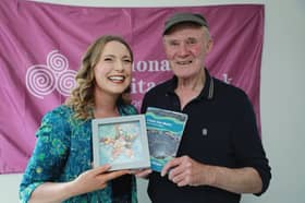 Aedín Ní Thiarnaigh who researched and wrote the booklet making a presentation to Taimín Meachair for his contributions. 
