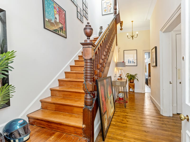 A welcoming entrance vestibule leads into the generous reception hallway, with two useful storage cupboards and an impressive staircase rising to the upper floor.
