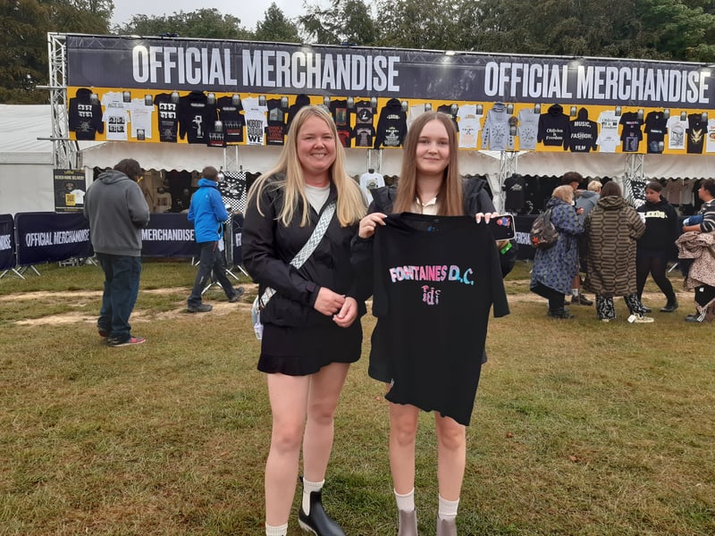 A couple of festivalgoers made a stop by the merch stand - and picked up a Fontaines DC top