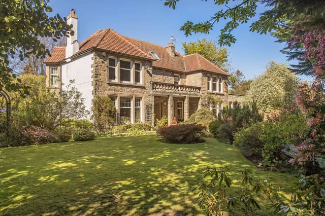 The expansive front and rear gardens are a defining feature, offering exceptional privacy and year-round interest, while a fountain enhances the front garden.