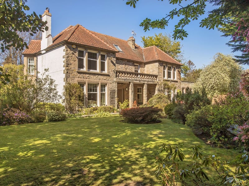The expansive front and rear gardens are a defining feature, offering exceptional privacy and year-round interest, while a fountain enhances the front garden.