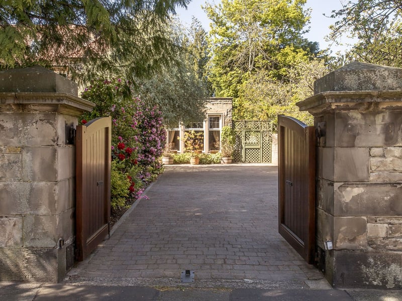 Secure gates open onto a broad driveway with ample parking and access to a detached garage. Extensive external lighting throughout the garden, including the decking, creates a welcoming ambience and allows the outdoor spaces to be enjoyed after dusk. Three garden sheds and a separate log store provide plentiful storage.