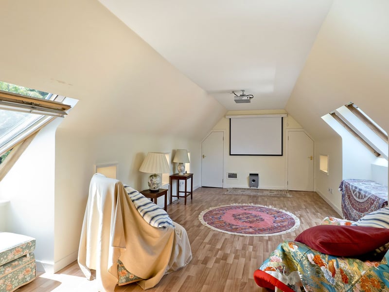 Above, this large floored attic is currently set up as a cinema room, with two areas of eaves storage and exciting additional space for older children, hobbies, or household storage.