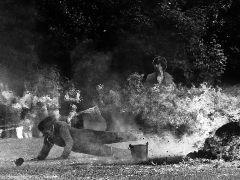 Wolverhampton stuntman Johnny Carr crawls clear after diving from a speeding motorbike into bales of burning hay at Wightwick Hall School's fete in Compton in July 1975. He lost his crash helmet during the stunt and escaped with little more than singed hair. The school, at Tinacre Hill, catered for children with disabilities, and the fete also featured local entertainment. Do you remember the Wightwick Hall school fetes, or seeing Johnny Carr perform?