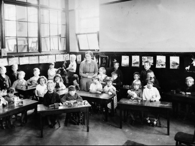 Note the little boy on a hobby horse and the pictures of a liner, train, and bus on the classroom wall. It's just possible one or two of these youngsters is still alive and, while they're unlikely to remember their classroom, they might recognise their old teacher. The picture was at our Newport office, which will give an idea of the likely general area.