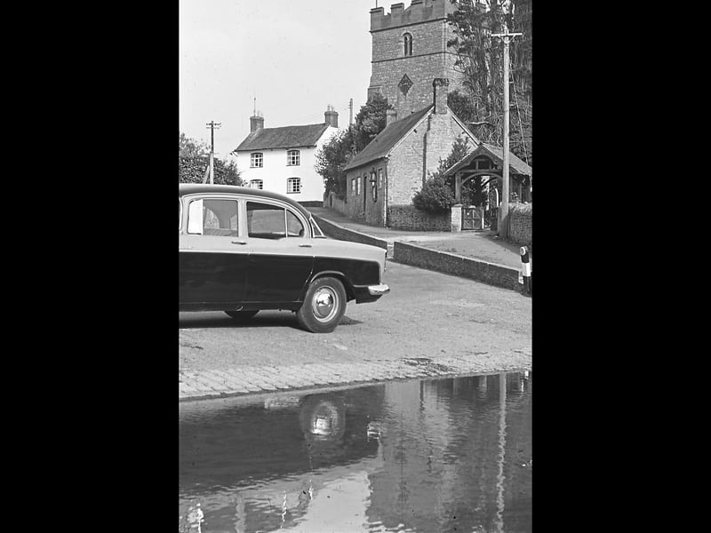 Diddlebury village is pictured in 1962, with the ford in the foreground and Diddlebury Church rising beyond it. The photograph was taken during an outing by Bridgnorth and District Camera Club and was shared by Ralph Walker of Bridgnorth. With the water running through the village and the church providing a familiar landmark, it is a scene that feels a world away from today. Can you remember using the ford at Diddlebury? Do you recognise this view?