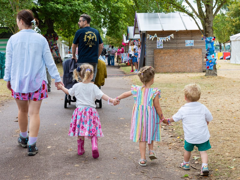 A family wanders through the festival grounds on Sunday, August 30.