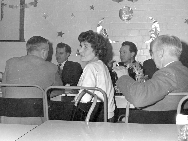Those metal framed chairs were made for utility, rather than comfort. This lady at one of the tables may be watching the dancers. The gentleman on the right is having a cigarette. Nobody would have complained about him smoking in company. Indeed, it was entirely normal in those days.