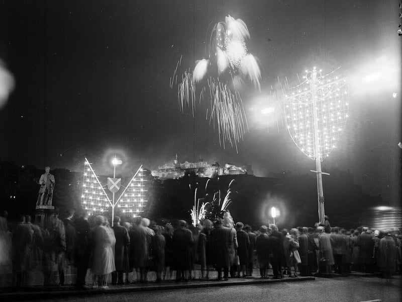 Crowds on Princes Street enjoying watching the fireworks to mark the opening of the 1963 Edinburgh Festival.