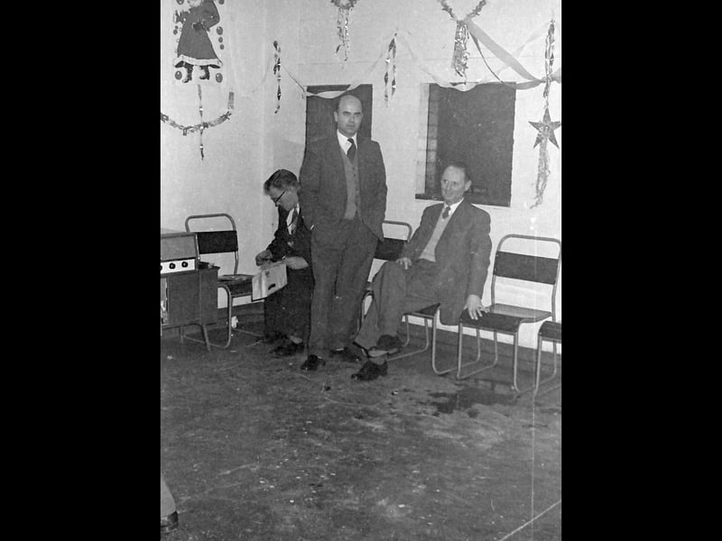 The man in the corner is looking at something, but it's difficult to tell what. And there's something on the chair too. Records perhaps? We can only imagine what sort of music they played on that winter evening so long ago.