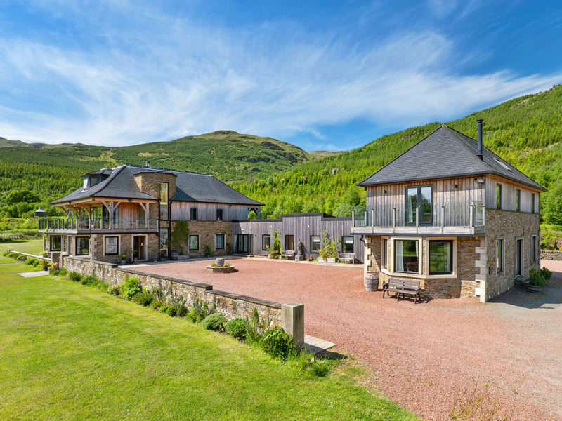 Carrick Castle Estate, near Lochgoilhead in Argyll and Bute, occupies an elevated position overlooking Loch Goil and combines a substantial contemporary principal house with additional residential properties, woodland, meadow, event space and direct access to the shoreline.