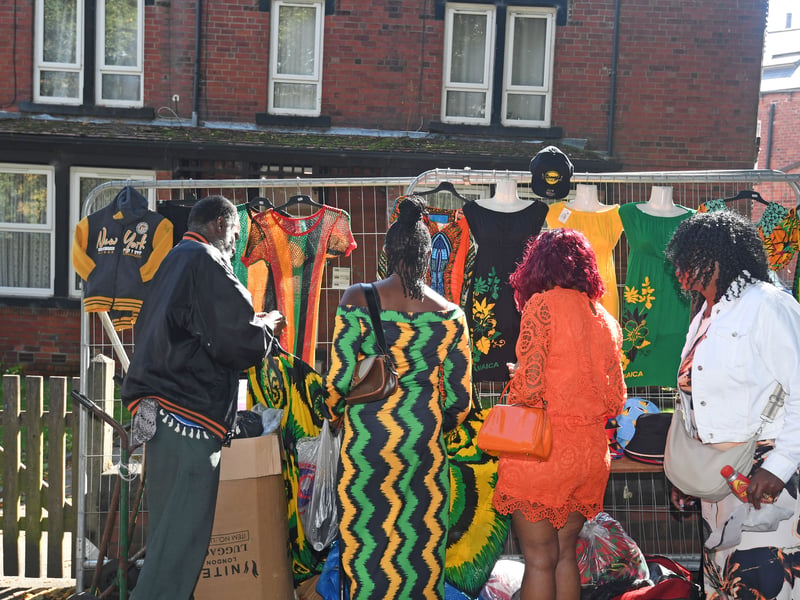 Shoppers exploring stalls on the street around  Potternewton Park.