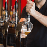 Barman pulling a pint stock image