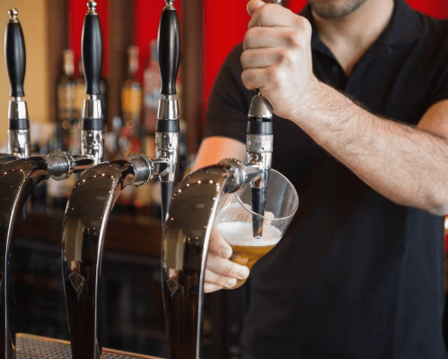 Barman pulling a pint stock image