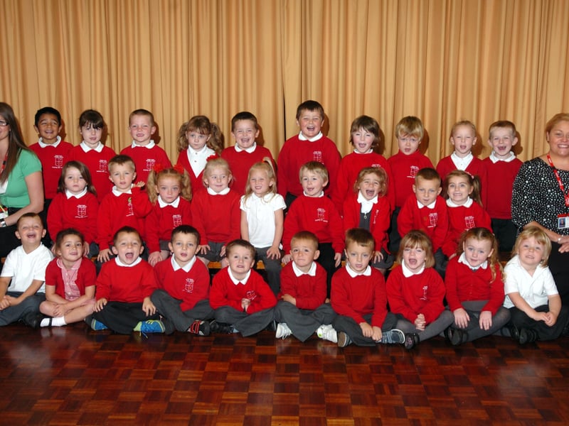 The reception class lined up for their first photo at Plains Farm Primary School in 2011.
Joining them were teacher Louise Greenland and Nursery Nurse Lisa Walker, right.