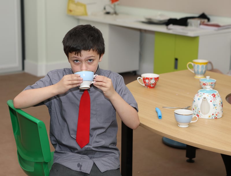 Elliott Burns enjoying a cup of tea in his new classroom