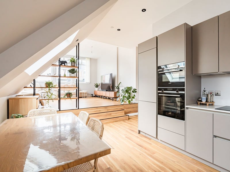 The kitchen is fitted with a superb range of sleek modern units, coordinated worktops, space for a table and chairs, and a variety of quality integrated appliances.