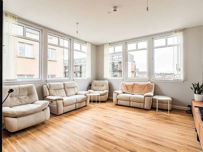The generous dual-aspect sitting, dining and kitchen area enjoys west- and south-facing light, creating a stylish contemporary space for relaxing, dining and entertaining.