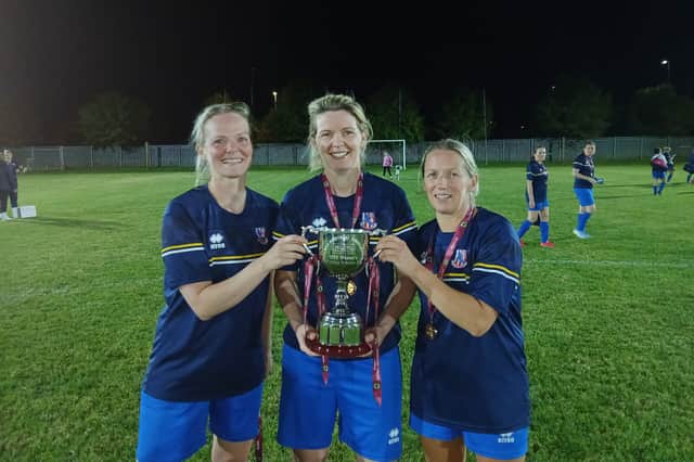 Pictured with the league silverware were the team's top-scorer, Rachael Stuart (left), who scored in the final, as did Suzie Cunningham (centre); with team captain, Melissa Fleming.