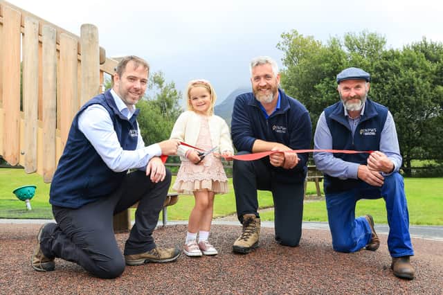 Mia Suhr cutting the ribbon on Connemara National Park's new children's playground, with (from left) Eugene Finnerty, NPWS; Minister of State Christopher O’Sullivan, and NPWS Foreperson Martin Coyne.