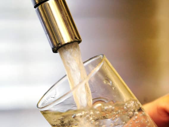 Water pouring into a tap