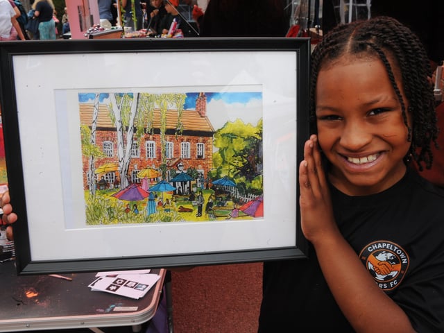 Chapeltown Juniors are raising money to send teams to Barcelona for a tournament pictured is Lovelle Stewart, nine, with a painting of The Mustard Pot done by his head coach Stuart Ramsay.