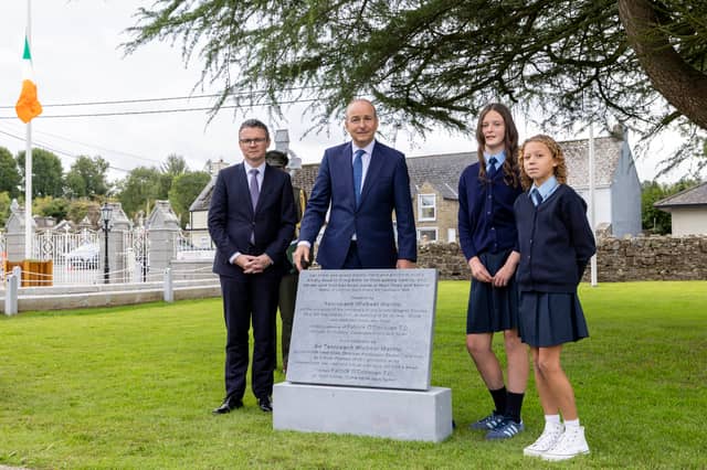 Sixth class students Sadie Scollard and Amelia Nix unveiling the plaque with An Taoiseach Micheál Martin TD and Minister O'Donovan