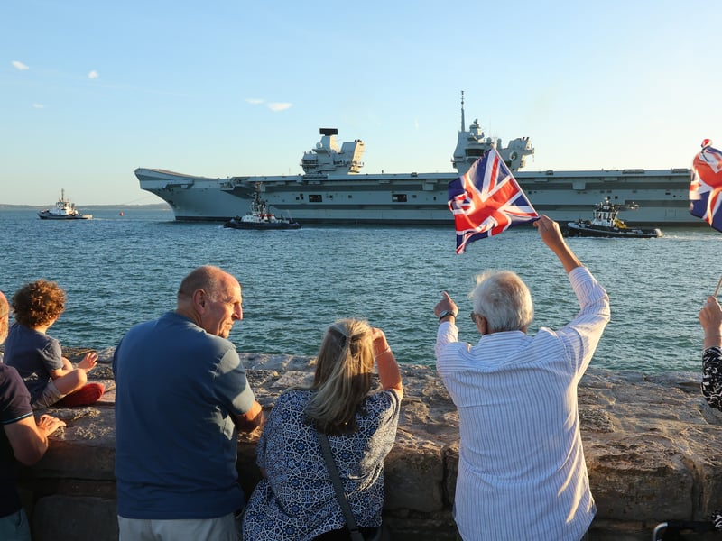 HMS Queen Elizabeth is waved off from the Hotwalls in Old Portsmouth.