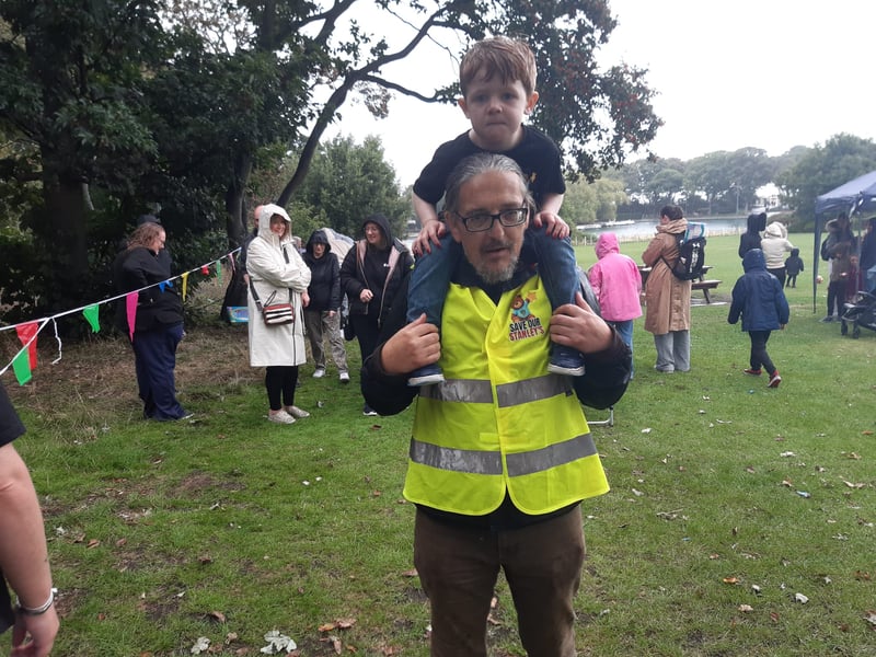 This youngster enjoys a shoulder carry from his dad.