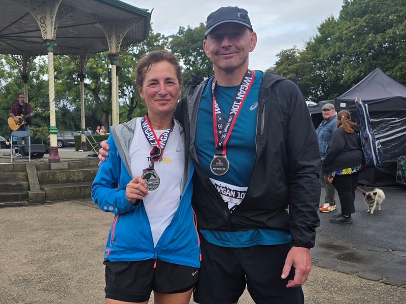 Two runners with their medals