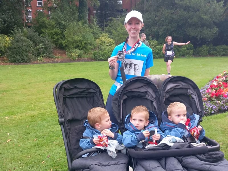 Lauren Winow with her triplets as she finished her 38th daily run, in honour of the number of days her sons were in the neo natal unit in Wigan