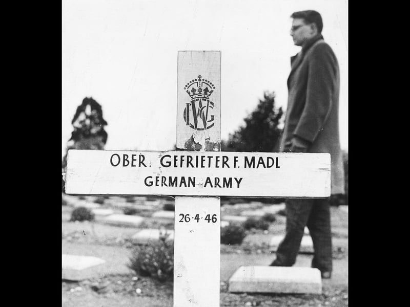 A West German official stands thoughtfully beside a wooden marker cross in the military cemetery on Cannock Chase in March 1962. Ahead of plans to establish a central German War Cemetery at Broadhurst Green, bringing together the remains of thousands of German servicemen buried across the UK, inspectors noted slight spelling errors made by English memorial painters, such as Gefrieter instead of Gefreiter. Politeness prevailed during the official visit, with the gentle corrections quietly scheduled for rectification as the site was developed into a lasting place of pilgrimage and remembrance. Do you remember visiting the Cannock Chase German Military Cemetery when it was first established in the 1960s?
