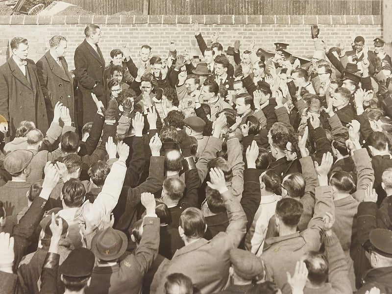 Bus crews gather at Walsall Bus Depot in March 1962, raising a sea of hands to vote in favour of returning to work following industrial action. Addressing the crowd from the platform are Transport and General Workers Union district organiser Mr H Fullelove, branch chairman Mr F Martin, and branch secretary Mr F Lunt. The mass meeting brought a swift resolution to the dispute, ensuring Walsall’s iconic blue-and-yellow buses were back on the roads to serve local commuters the very next morning. Do you remember relying on the buses around Walsall or catching the news of the depot vote back in 1962?