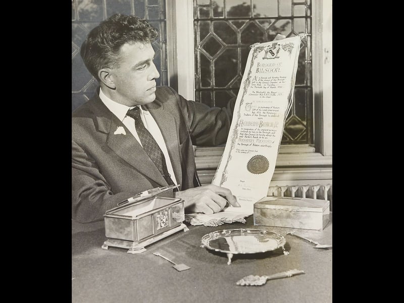 Borough Librarian Mr L E Taylor carefully examines an illuminated scroll in September 1962, part of a remarkable collection of civic gifts donated to Bilston Borough Museum by the family of the late Alderman Herbert Beach. The treasures include an ornate silver casket housing the scroll that awarded Alderman Beach the Freedom of the Borough in 1950, making him the first person to receive the honour. Alongside a silver salver presented to him as Charter Mayor in 1933, these historic pieces offer a fascinating window into Bilston’s rich municipal history. Do you remember seeing the civic gifts or visiting Bilston Museum when the collection first went on display in the 1960s?