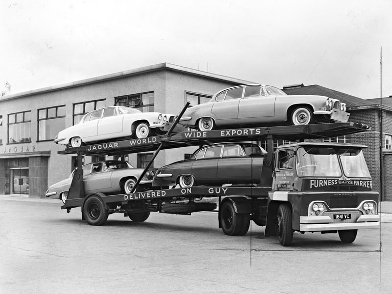 A powerful Guy Warrior tractor unit stands loaded with four sleek Jaguar Mark X saloons in July 1962. Measuring nearly 17 feet long, Jaguar’s luxury flagship model posed a logistical challenge for standard car transporters moving vehicles between the factory and the docks for overseas orders. To solve the problem, a specially extended double-deck transporter was coupled to a lorry built by Guy Motors (Europe) Ltd of Wolverhampton, a company that had recently become a subsidiary of Jaguar itself. Do you remember seeing Guy Motors transporters loaded with shiny new export cars heading out on local roads in the 1960s?