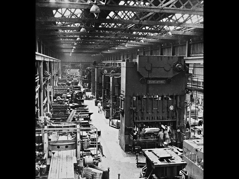 Towering Wilkins & Mitchell power presses line the busy factory floor at the Willenhall Motor Radiator Co, Ltd in July 1962. This impressive line-up of heavy machinery was set for further enlargement as part of a major post-war expansion programme at the works. Supplying pressed steel body panels, cabs, and components to Britain's thriving motor industry, the Willenhall factory played a crucial role in cementing the Black Country's reputation as the industrial heartland of British automotive manufacturing. Did you or any of your relatives work alongside these giant press machines at Willenhall Motor Radiator in the 1960s?