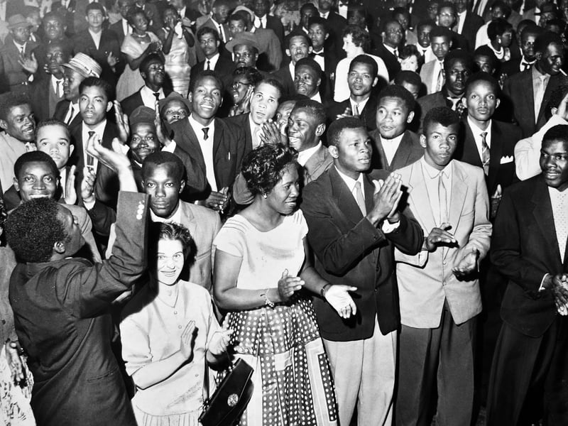 A packed crowd claps and cheers at the Wulfrun Hall as the newly unveiled Jamaican flag is raised during an exuberant independence dance on August 6, 1962. Dressed in their finest suits and party dresses, members of Wolverhampton's Caribbean community gathered to mark the historic moment Jamaica officially gained its independence. The joyous event brought a powerful sense of pride, unity, and celebration to the heart of the town. Did you or your family attend any of the Jamaican independence celebrations in Wolverhampton back in August 1962?