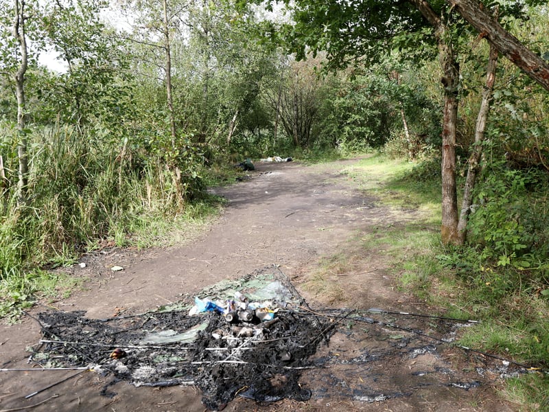 Burnt rubbish on a footpath in the nature reserve