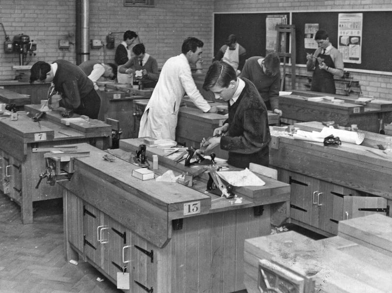 Students focus intently on their woodwork at individual workbenches in the carpentry shop at the new Wulfrun College of Further Education on March 21, 1962. Kitted out with planes, vices, and specialist hand tools, the modern workshop block was built to provide top-tier vocational training for young apprentices heading into the region's bustling construction and manufacturing trades. The opening of the college marked a major leap forward in expanding further education opportunities across the town. Did you or a family member learn a trade at Wulfrun College during its early days in the 1960s?