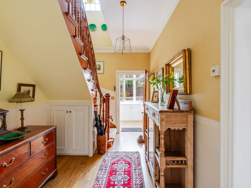 The property is entered via a charming porch, which opens into a welcoming hallway with the grand staircase rising to the upper floor. The first floor provides four bedrooms, with each room benefiting from the generous proportions characteristic of the property. A well-appointed bathroom completes the first-floor accommodation.