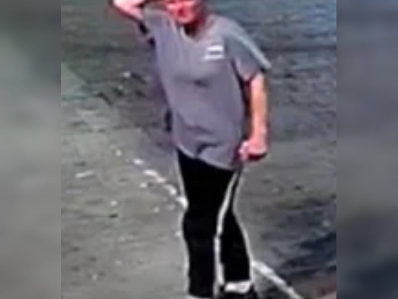 Female with brown hair tied back, grey/blue long t-shirt, black joggers with a stripe down the leg.
