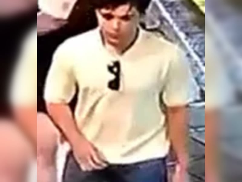 Man, white t-shirt, sunglasses attached to t-shirt, jeans.