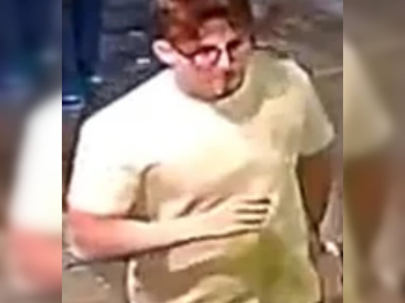 Man, white shirt, grey jeans and glasses on face.