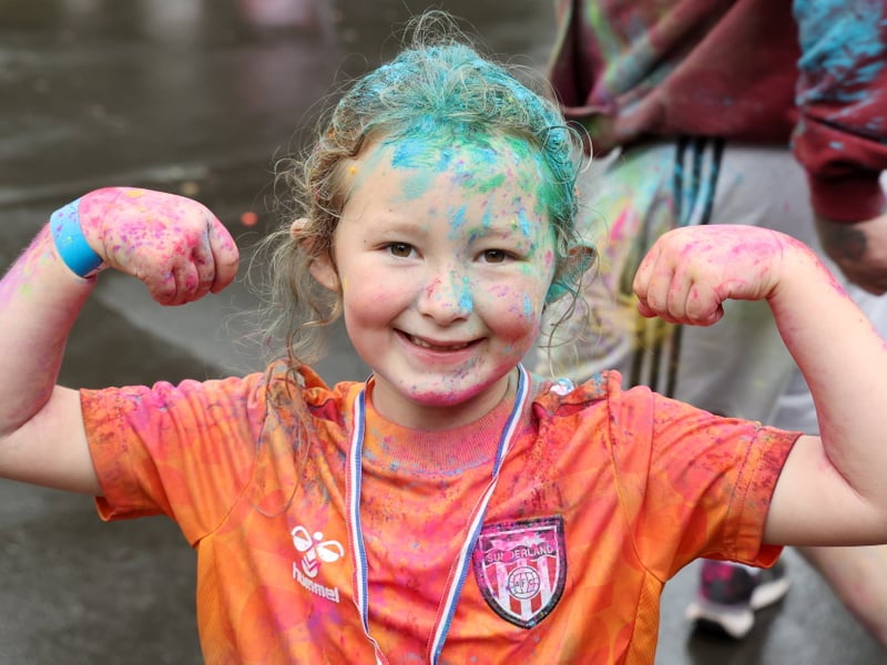 Darcy, 6, celebrates crossing the finish line.