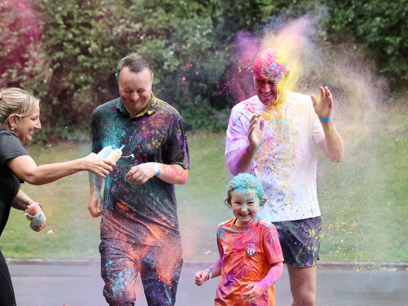 Paul Thompson, Andy Smith and Darcy, aged 6, taking part in the festival's Colour Run. 